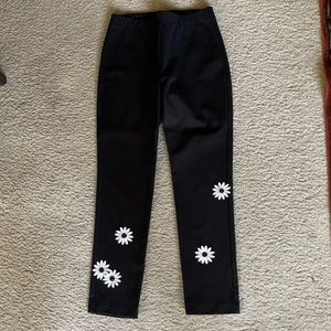 Karen Kane black pants with white daisies.